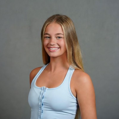 Smiling blonde teenage girl in blue tank top
