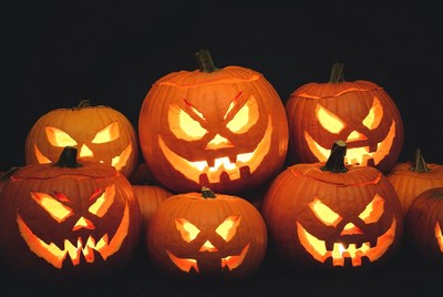 Jack-o'-lantern pumpkins on black background