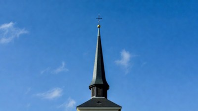 Church Steeple with Cross Against Blue Sky