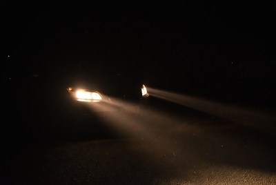 Car headlights in dark night