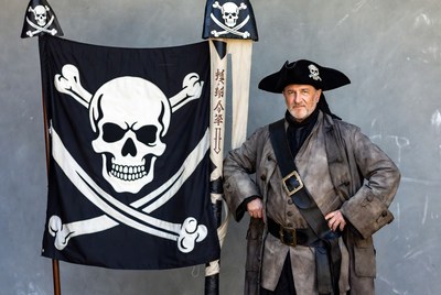 Pirate man with Jolly Roger flags