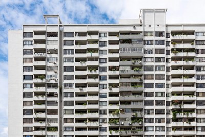 Tall White Apartment Building with Balconies