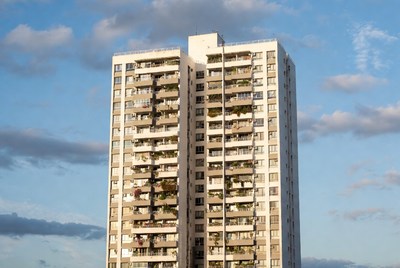 Tall White Apartment Building with Balconies
