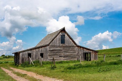 Old Wooden Barn in Green Field