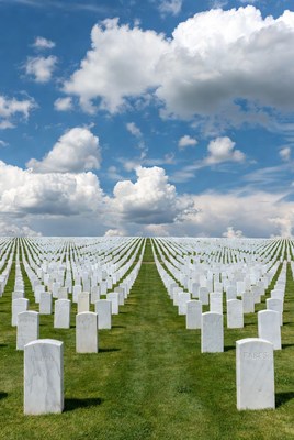Rows of White Headstones in Cemetery
