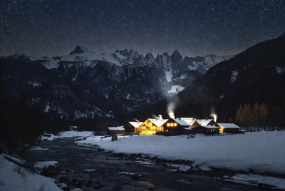 Snowy Chalet Village in Mountains at Night