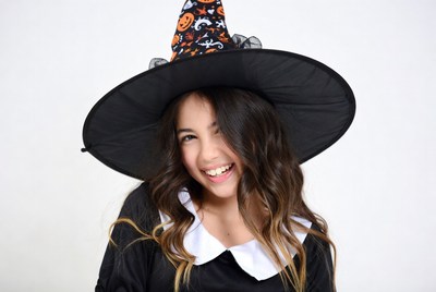 Girl smiling in witch Halloween hat