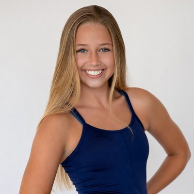 Smiling blonde girl in blue camisole