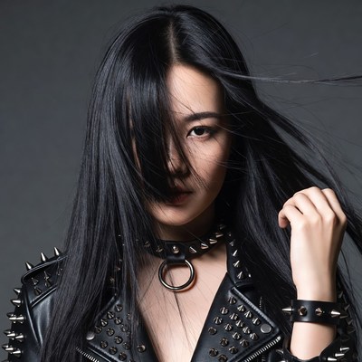 Asian woman in spiked leather jacket