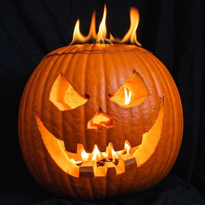 Lit Jack-o-Lantern Pumpkin on Black Background