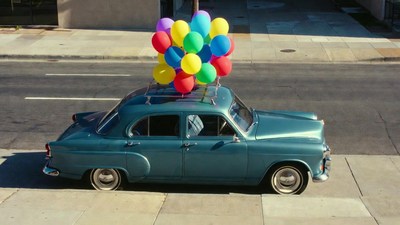 Vintage Car Roofed with Colorful Balloons