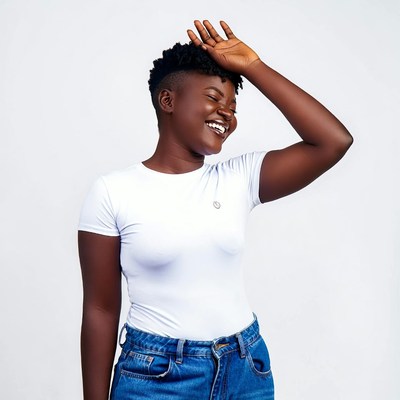 African woman laughing with hand on head