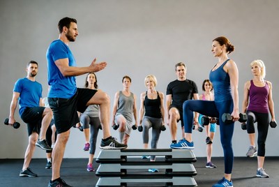 Fitness instructor leading step aerobics class