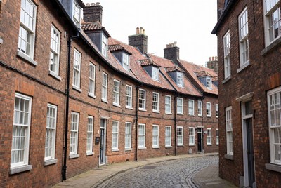 Curved Cobblestone Street with Brick Houses