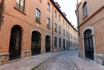 Curved Cobblestone Street with Brick Buildings