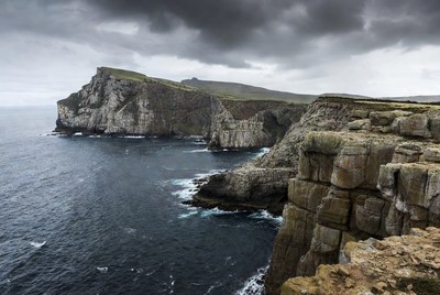 Dramatic Cliffs Over Ocean Stormy Sky