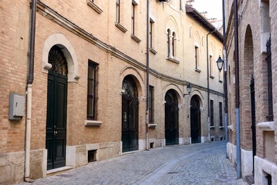 Narrow cobblestone alley with brick buildings