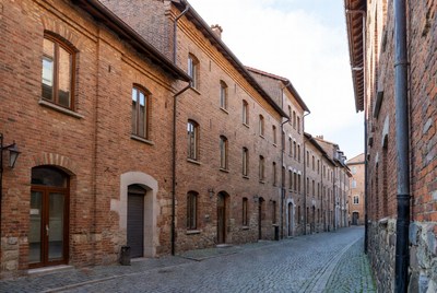 Narrow Cobblestone Street with Brick Buildings