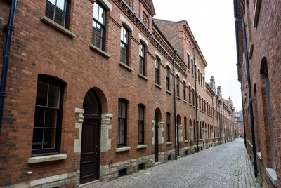 Red Brick Buildings Along Narrow Cobblestone Alley