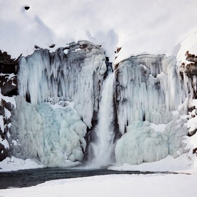 Frozen Waterfall in Snowy Landscape