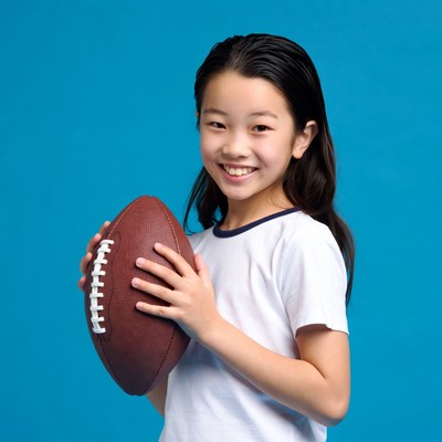 Asian girl holding football
