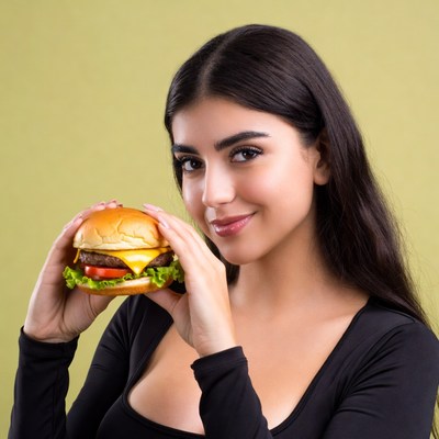 Woman holding cheeseburger