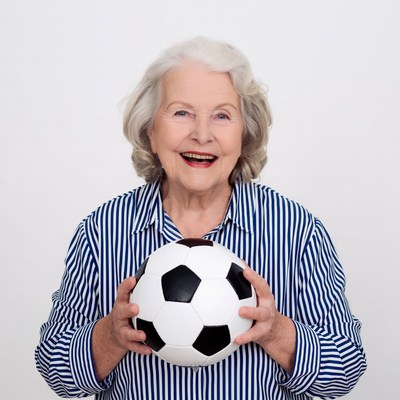 Elderly woman holding soccer ball