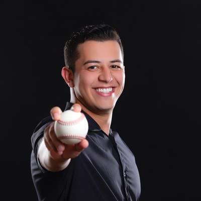 Latino man holding baseball