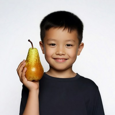 Asian boy holding pear