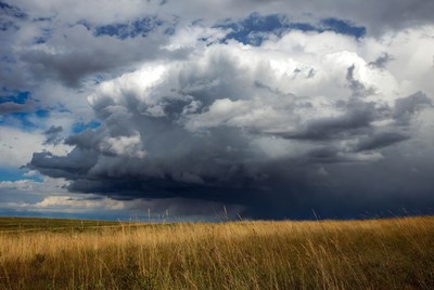Massive Cumulonimbus Cloud Over Grass Field