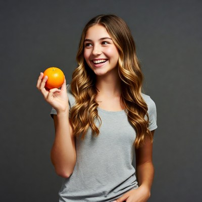 Teen girl holding orange