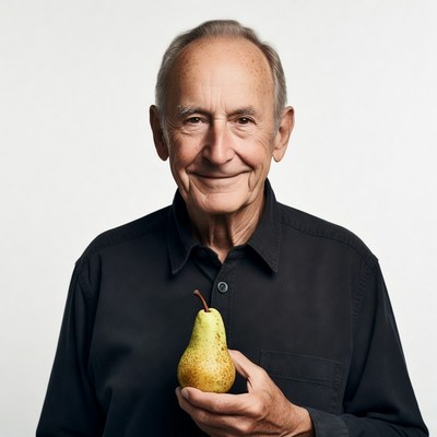Elderly man holding green pear