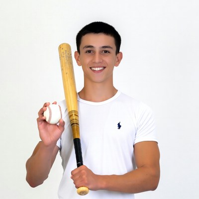 Boy holding baseball bat and ball