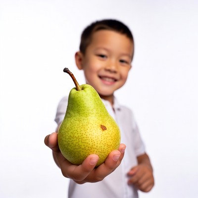Asian boy holding green pear