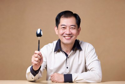 Asian man holding spoon