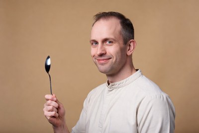 Man holding silver spoon