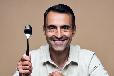 Man holding silver spoon
