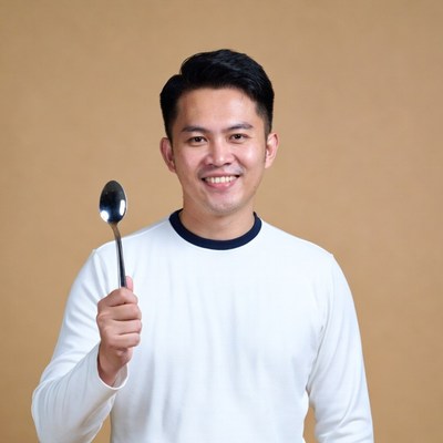 Asian man holding spoon