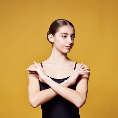 Teen girl crossing arms on yellow background