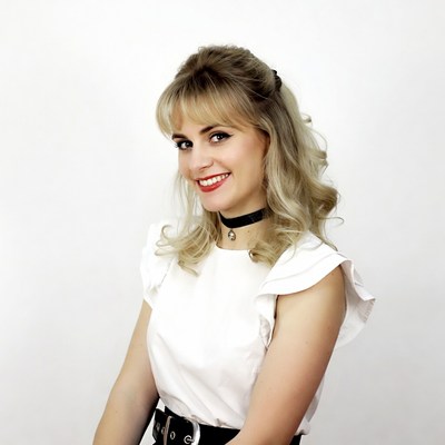 Smiling blonde woman in white blouse