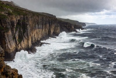 Stormy Ocean Crashing Against Cliffs