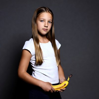 Girl holding banana