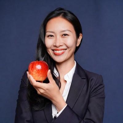 Asian woman holding red apple
