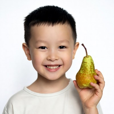 Asian boy holding green pear