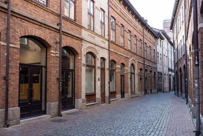 Narrow cobblestone alley with brick buildings