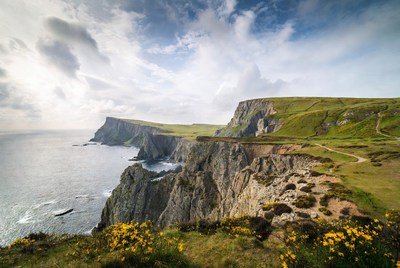 Cliffed Coastline with Green Hills and Ocean