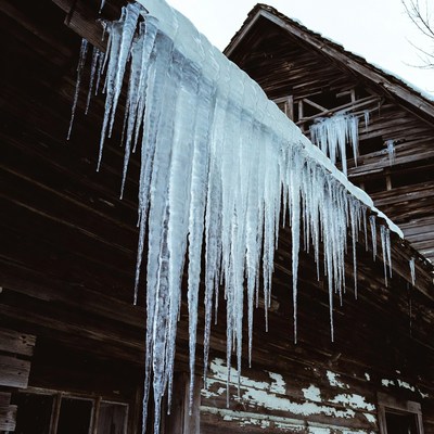 Icicles hanging from old wooden roof