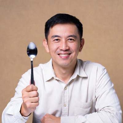 Asian man holding spoon