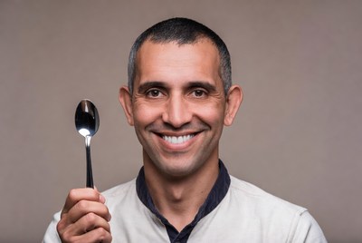 Man holding silver spoon
