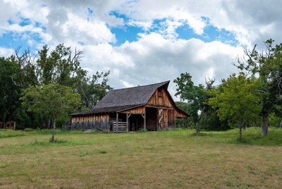 Old Wooden Barn in Grassy Field